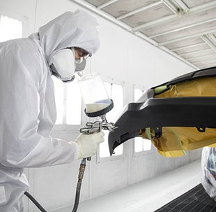 Collision Center Technician Painting a Vehicle | SouthWest Toyota of Lawton in Lawton OK