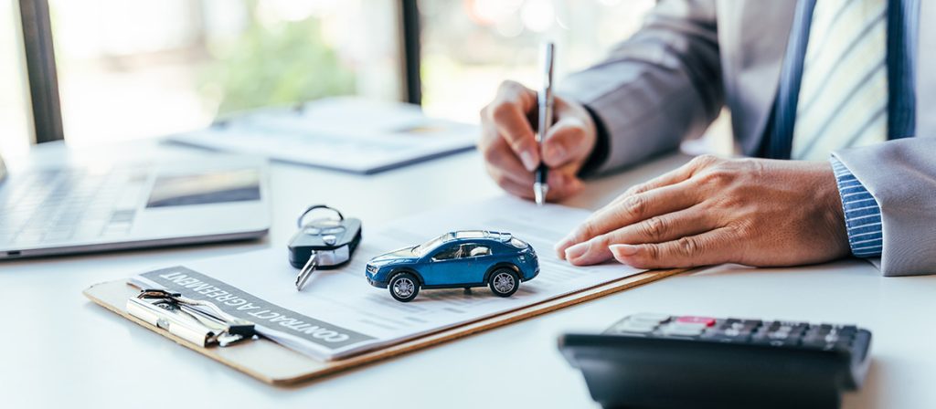 Customer signing car lease documents